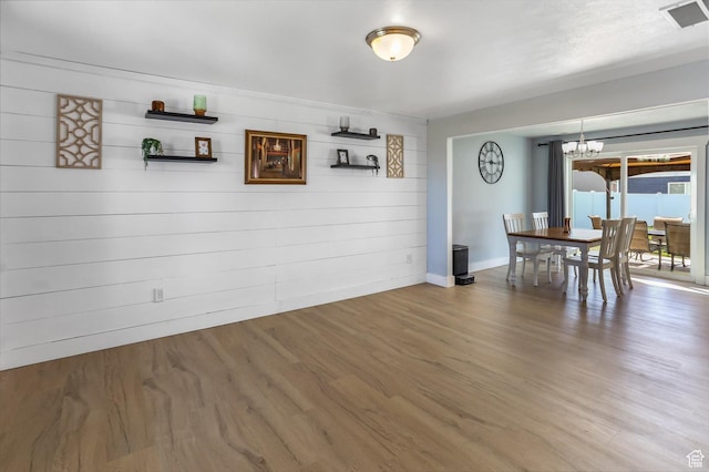 1150 W 200 S, Logan, UT 84321 - unfurnished dining area featuring visible vents, baseboards, wood finished floors, and a chandelier