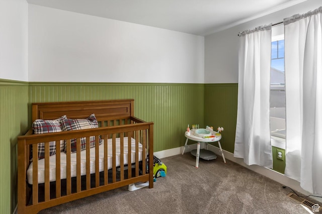 1150 W 200 S, Logan, UT 84321 - bedroom with a crib, wainscoting, carpet flooring, and visible vents