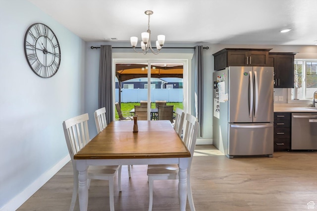 1150 W 200 S, Logan, UT 84321 - dining room with baseboards, a chandelier, and light wood-type flooring