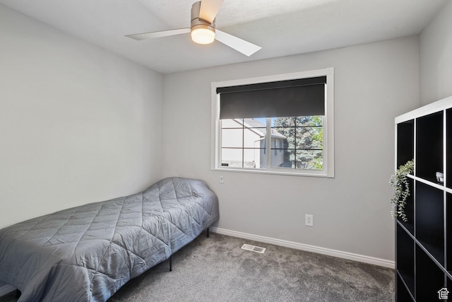 bedroom featuring a ceiling fan, visible vents, a skylight, baseboards, and carpet