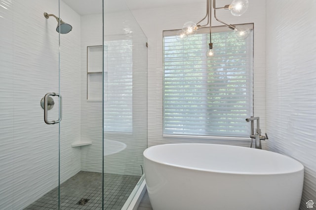 bathroom with a freestanding bath, tile walls, and a stall shower