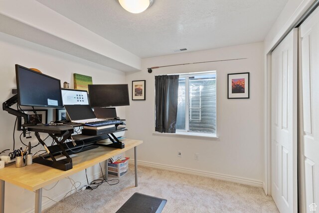 carpeted office with visible vents and baseboards