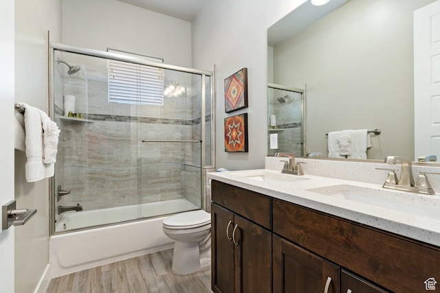 2600 Ocotillo Way Unit 31, Santa Clara, UT 84765 - bathroom with toilet, wood finished floors, bath / shower combo with glass door, and double vanity