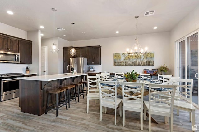 2600 Ocotillo Way Unit 31, Santa Clara, UT 84765 - kitchen with stainless steel appliances, dark brown cabinets, recessed lighting, a chandelier, and light countertops