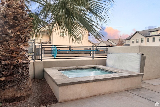 2600 Ocotillo Way Unit 31, Santa Clara, UT 84765 - pool at dusk featuring an in-ground hot tub and fence