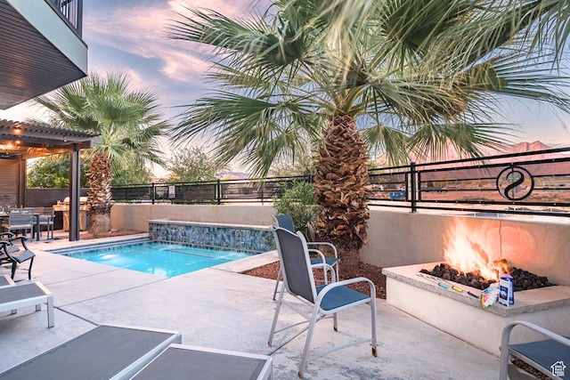2600 Ocotillo Way Unit 31, Santa Clara, UT 84765 - pool at dusk featuring a fenced backyard, a patio area, and an outdoor fire pit