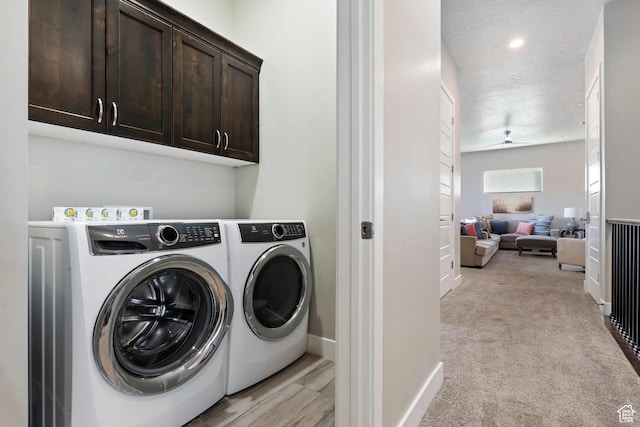 2600 Ocotillo Way Unit 31, Santa Clara, UT 84765 - laundry room with cabinet space, washer and clothes dryer, baseboards, and light carpet