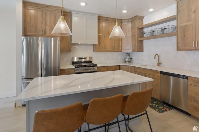 3030 S 400 W, Nibley, UT 84321 - kitchen with open shelves, appliances with stainless steel finishes, a sink, a kitchen bar, and backsplash