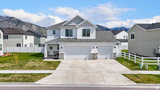 3030 S 400 W, Nibley, UT 84321 - view of front of home with a front lawn, fence, concrete driveway, an attached garage, and a mountain view