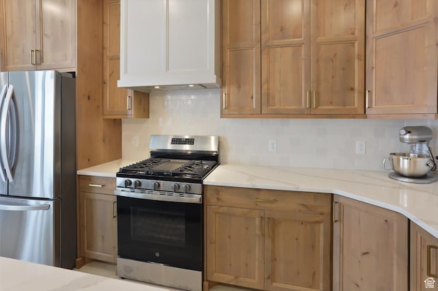 3030 S 400 W, Nibley, UT 84321 - kitchen with light stone counters, decorative backsplash, appliances with stainless steel finishes, and custom range hood