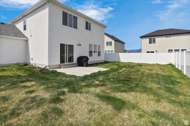 3030 S 400 W, Nibley, UT 84321 - back of property featuring stucco siding, a lawn, fence, and a patio area
