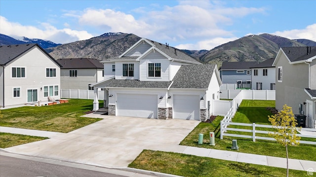 3030 S 400 W, Nibley, UT 84321 - view of front of home with a garage, a mountain view, concrete driveway, and a front lawn