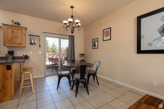 300 E 300 N Unit L5, Kanab, UT 84741 - dining space featuring a chandelier, baseboards, and light tile patterned flooring
