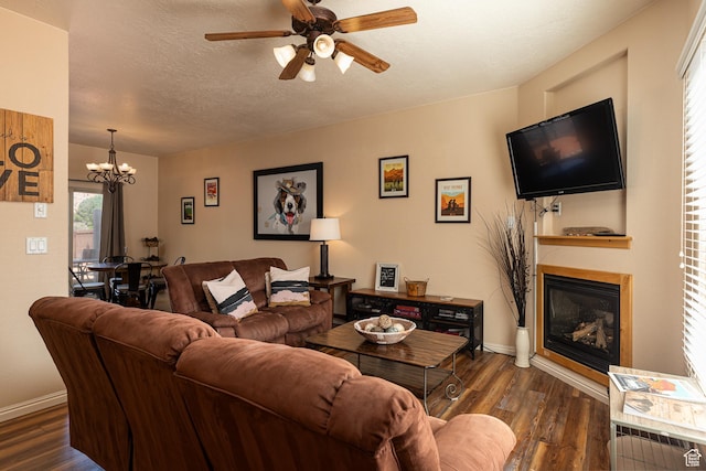 300 E 300 N Unit L5, Kanab, UT 84741 - living room featuring a glass covered fireplace, a chandelier, dark wood-type flooring, a ceiling fan, and baseboards