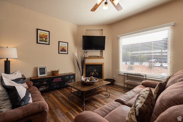 300 E 300 N Unit L5, Kanab, UT 84741 - living area featuring a glass covered fireplace, wood finished floors, ceiling fan, and baseboards