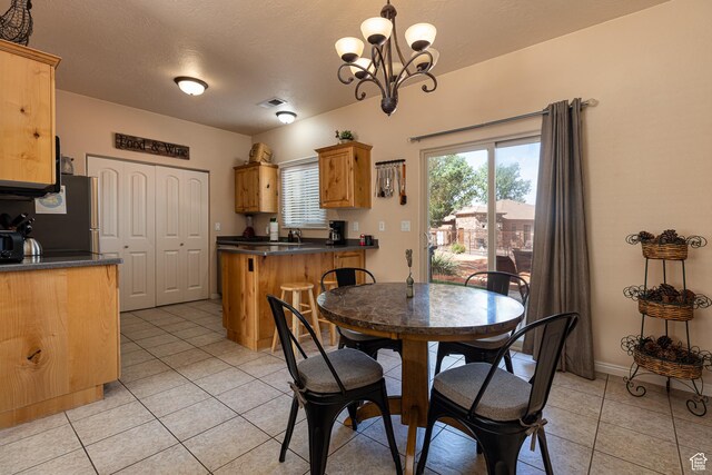 300 E 300 N Unit L5, Kanab, UT 84741 - dining area with light tile patterned floors, a chandelier, and baseboards