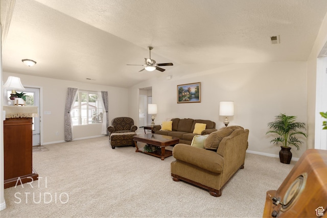 living area with vaulted ceiling, baseboards, ceiling fan, and carpet flooring