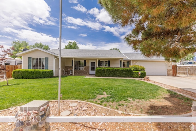 single story home featuring a front lawn, fence, covered porch, concrete driveway, and an attached garage