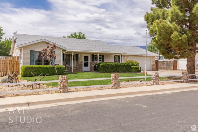 single story home featuring a porch, a front yard, fence, concrete driveway, and an attached garage
