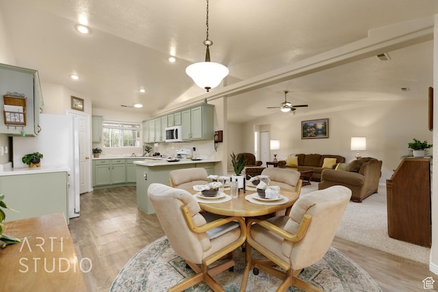 dining area with recessed lighting, light wood finished floors, ceiling fan, and vaulted ceiling