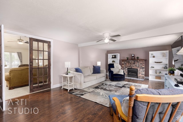living room with french doors, a ceiling fan, a fireplace, wood finished floors, and baseboards