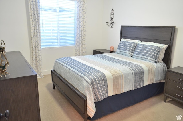 carpeted bedroom featuring multiple windows