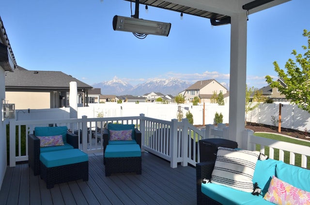 deck with outdoor lounge area, a residential view, and a fenced backyard