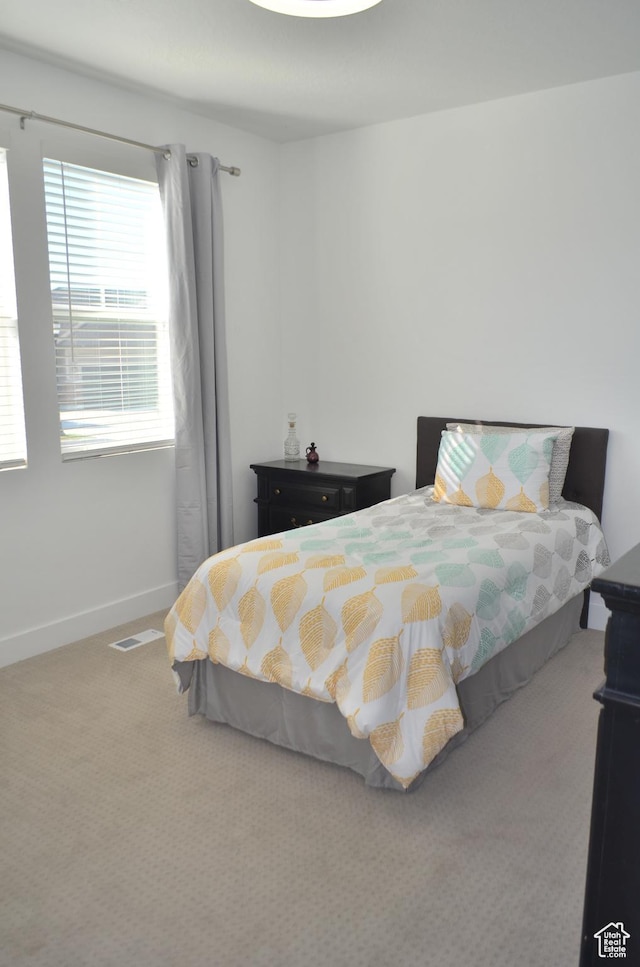 carpeted bedroom with baseboards