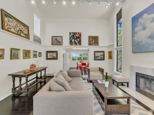799 Northpoint Ct, Salt Lake City, UT 84103 - living area featuring track lighting, plenty of natural light, a high ceiling, and a fireplace