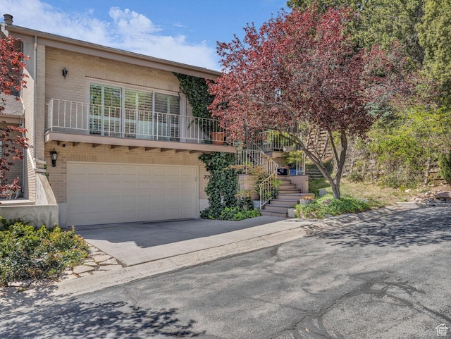 799 Northpoint Ct, Salt Lake City, UT 84103 - view of front of property with driveway, brick siding, and a garage