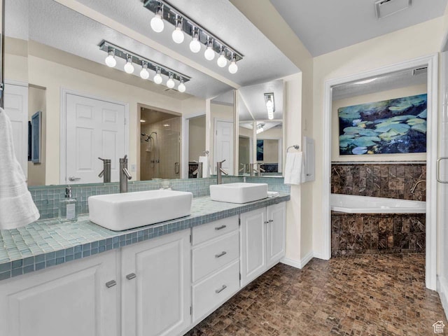 799 Northpoint Ct, Salt Lake City, UT 84103 - full bathroom featuring double vanity, a bath, a stall shower, and decorative backsplash