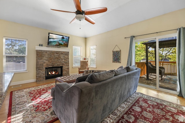849 E Forest Farm Cir S, Salt Lake City, UT 84106 - living area with a stone fireplace, a ceiling fan, baseboards, wood finished floors, and visible vents