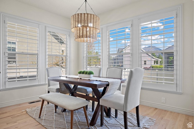 927 S Iris Ln W, Mapleton, UT 84664 - dining area with baseboards, a notable chandelier, and wood finished floors