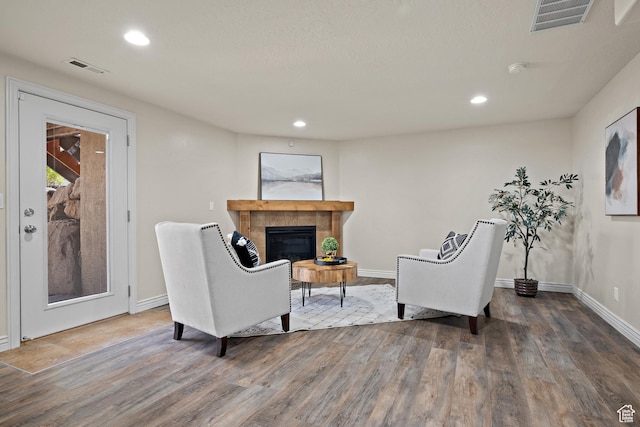 927 S Iris Ln W, Mapleton, UT 84664 - living area featuring a tiled fireplace, baseboards, wood finished floors, and visible vents