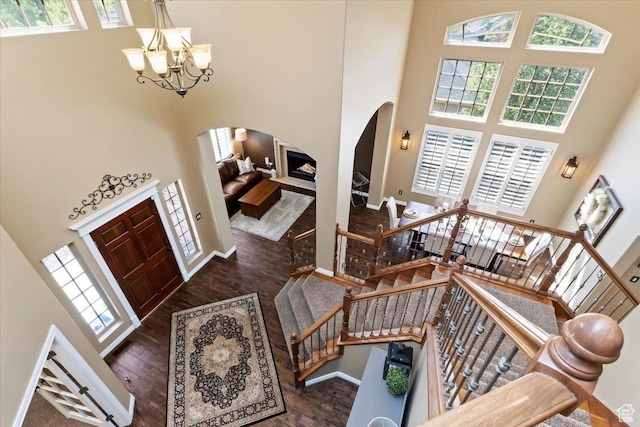2077 E Genova Dr S, Draper, UT 84020 - foyer entrance featuring arched walkways, a high ceiling, wood finished floors, and a wealth of natural light