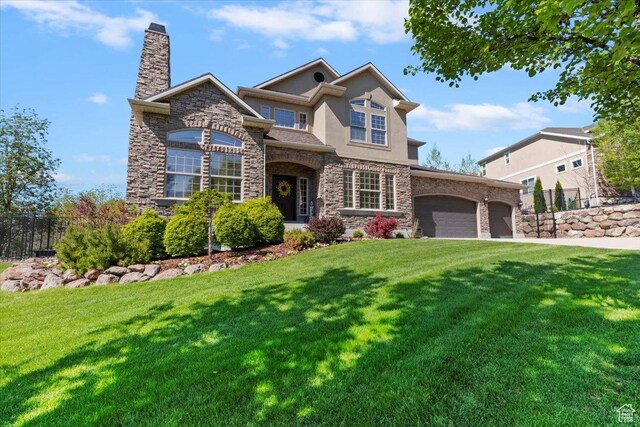2077 E Genova Dr S, Draper, UT 84020 - view of front facade featuring fence, a front lawn, stone siding, and a garage