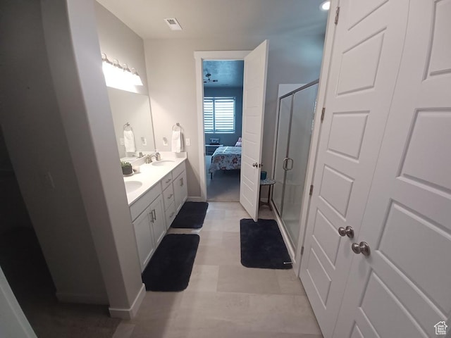 1831 S 2525 W Unit 103, West Haven, UT 84401 - ensuite bathroom featuring a stall shower, double vanity, baseboards, and tile patterned floors