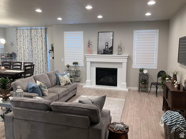 1831 S 2525 W Unit 103, West Haven, UT 84401 - living area featuring recessed lighting, light wood-style floors, a glass covered fireplace, and baseboards