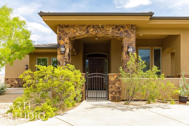 415 W Silver Hills Rd, Leeds, UT 84746 - view of exterior entry featuring stone siding, stucco siding, and fence