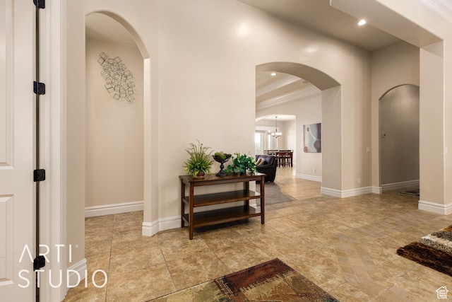 415 W Silver Hills Rd, Leeds, UT 84746 - hallway with arched walkways, baseboards, and an inviting chandelier
