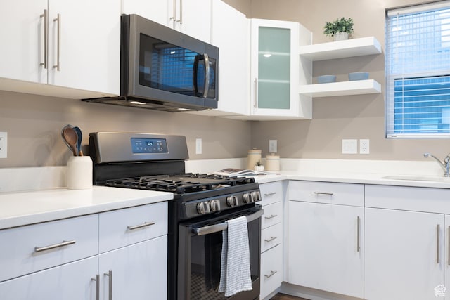 1602 E 3300 S, Millcreek, UT 84106 - kitchen featuring a sink, appliances with stainless steel finishes, white cabinets, and open shelves