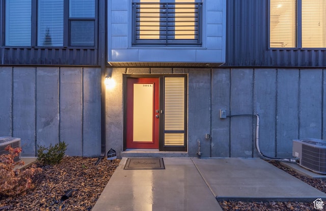 1602 E 3300 S, Millcreek, UT 84106 - doorway to property featuring board and batten siding and central air condition unit