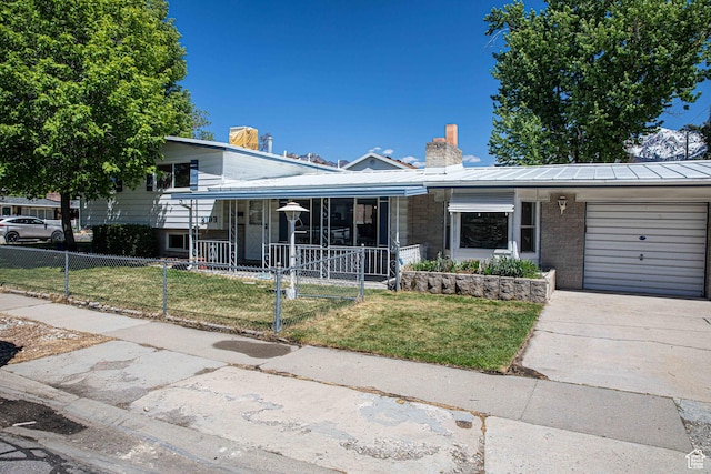 8193 S 1330 E, Sandy, UT 84093 - tri-level home featuring a chimney, an attached garage, covered porch, concrete driveway, and metal roof