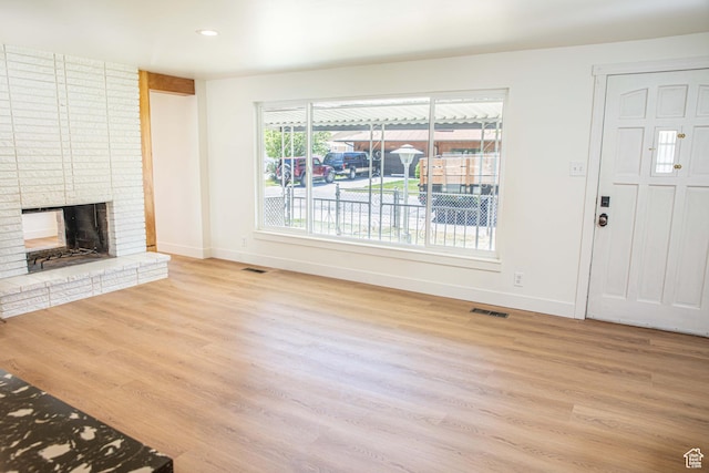 8193 S 1330 E, Sandy, UT 84093 - unfurnished living room with baseboards, wood finished floors, a brick fireplace, and recessed lighting