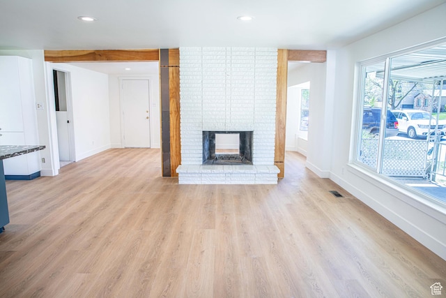 8193 S 1330 E, Sandy, UT 84093 - unfurnished living room with light wood-type flooring, baseboards, a brick fireplace, and recessed lighting
