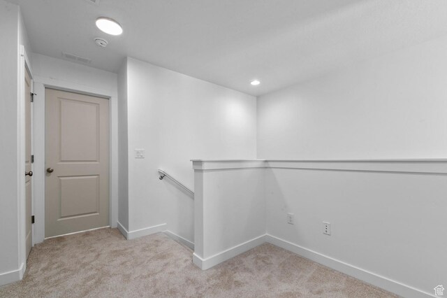 interior space featuring baseboards, carpet, and visible vents