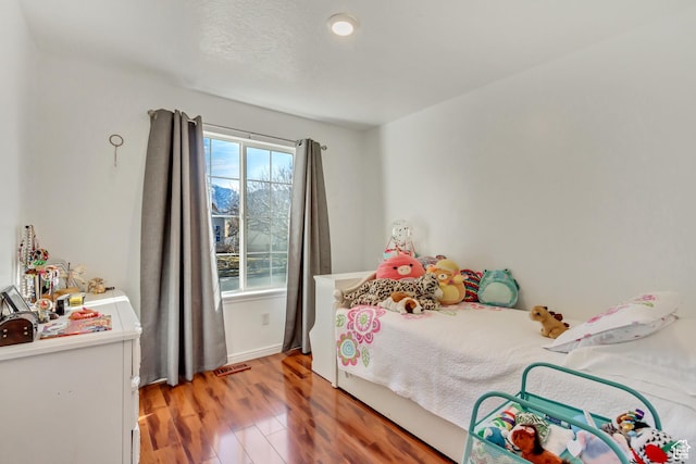 5943 N Genoa Ln W, Stansbury Park, UT 84074 - bedroom featuring visible vents and light wood-style floors