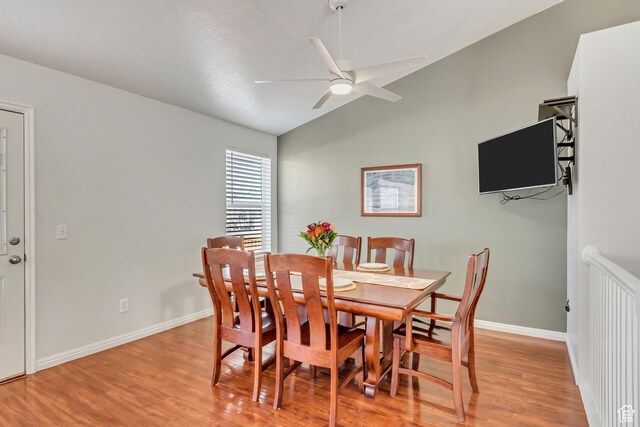 5943 N Genoa Ln W, Stansbury Park, UT 84074 - dining space featuring vaulted ceiling, baseboards, a ceiling fan, and light wood-style flooring
