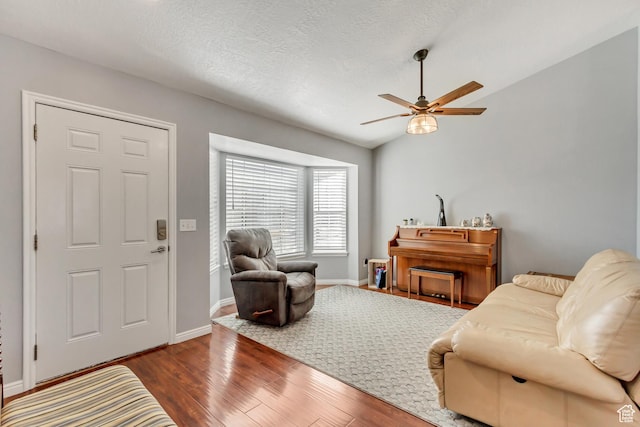 5943 N Genoa Ln W, Stansbury Park, UT 84074 - living room featuring a textured ceiling, baseboards, a ceiling fan, and wood finished floors