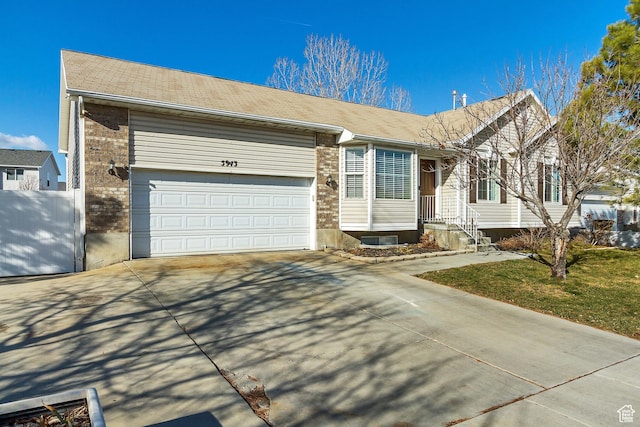 5943 N Genoa Ln W, Stansbury Park, UT 84074 - single story home featuring an attached garage, driveway, and brick siding